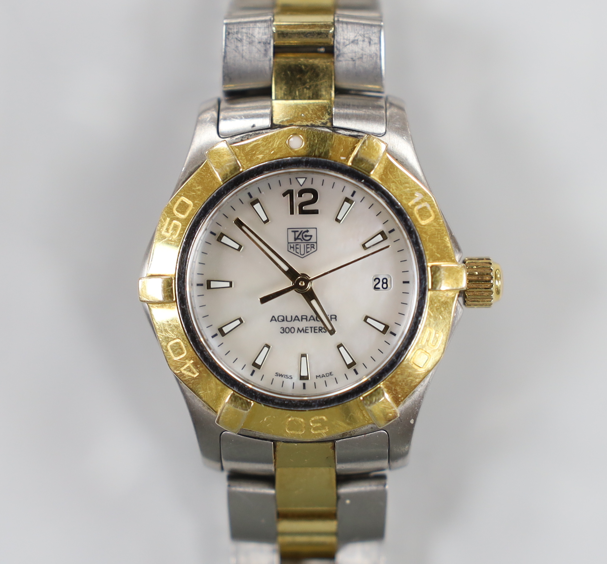 A lady's modern steel and gold plated Tag Heuer Aquaracer quartz wrist watch, with mother of pearl dial, no box or papers, with spare link.